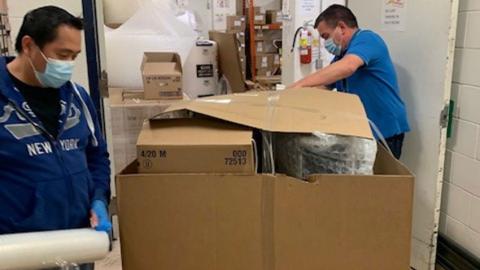 Staff are packing boxes with ventilators en route to India.