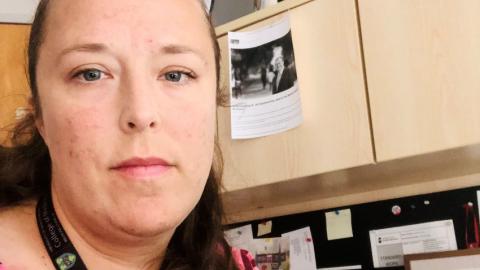 Dr. Jasmine Hasselback sits at her computer in her office.