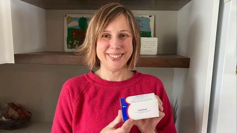 Patient with a box of Paxlovid