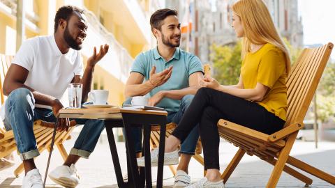 Three people engaging in a friendly conversation.