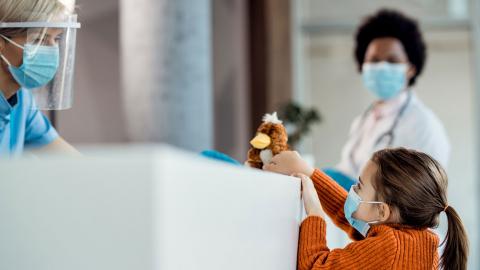 A little girl visits with a triage nurse.