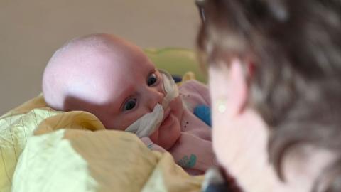 image of a baby being hugged