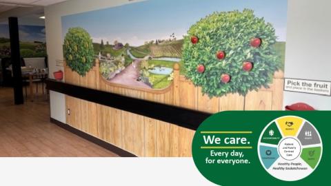 A photo of a wall featuring artwork of an apple orchard with the ability to 'pick the fruit' off the trees.