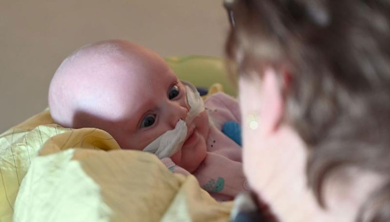 image of a baby being hugged