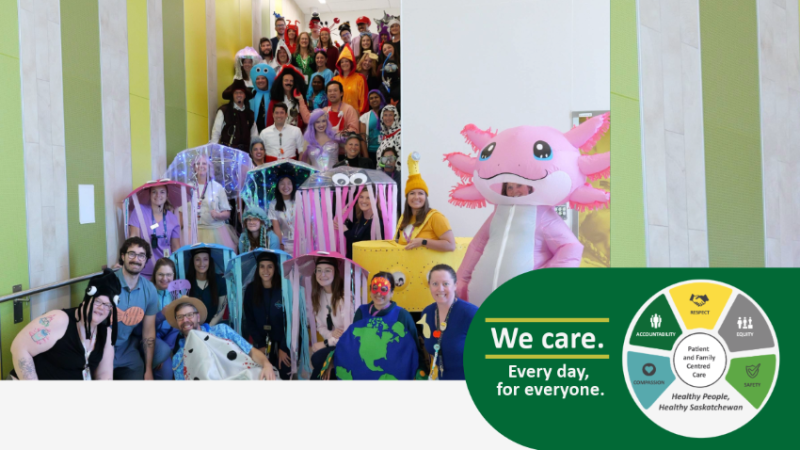 staff dressed in costumes pose on stairs