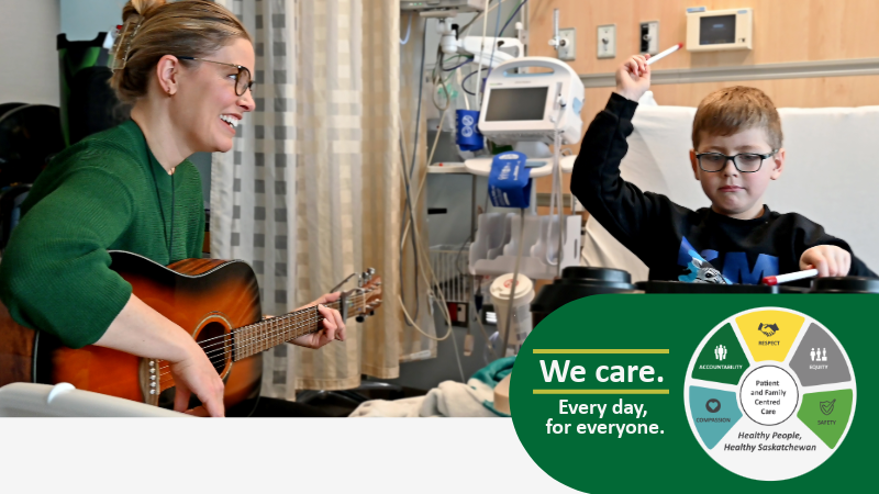 a music therapist plays a guitar while a young patient plays a drum