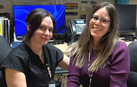 Two women sit together in an office