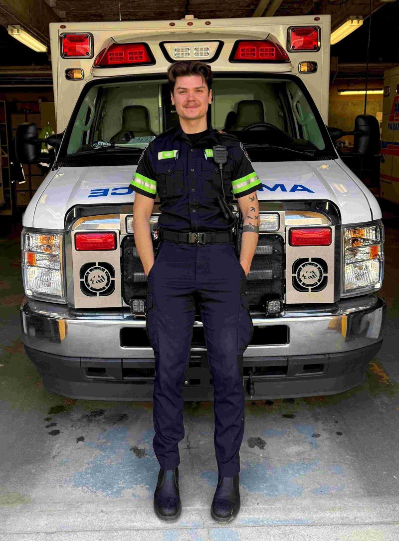 Denys Kotelnikov posing with ambulance